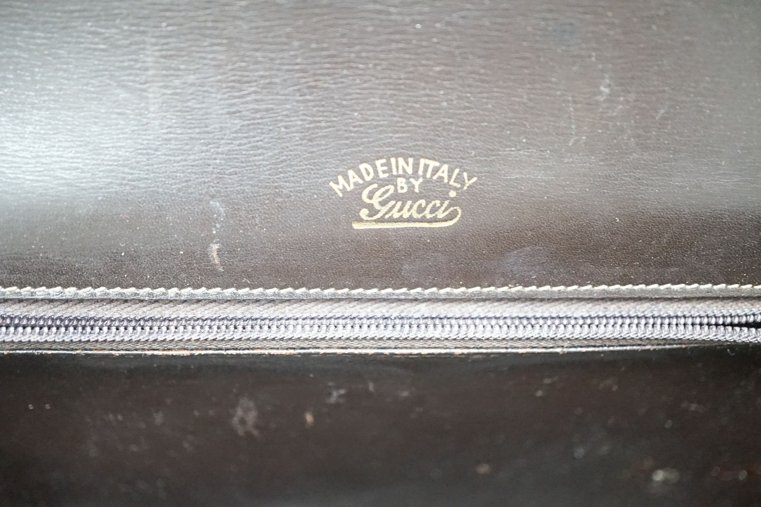 A vintage brown leather handbag stamped 
